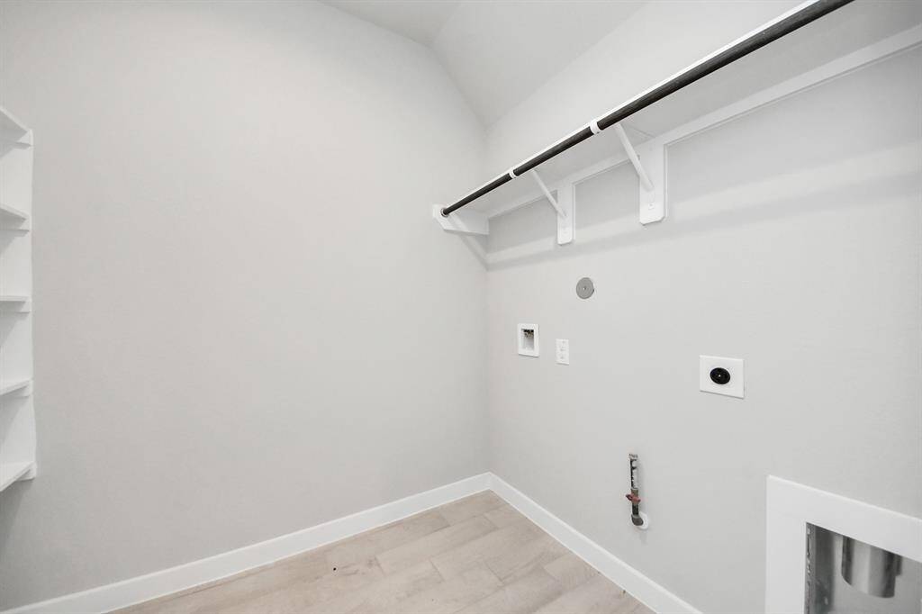 A perfect blend of functionality and comfort. Capture the essence of easy living with a first-floor laundry room, thoughtfully equipped with shelving for effortless organization. Bothelectric and gas connections available. Sample photo of completed home with similar floor plan. Actual colors and selections may vary.