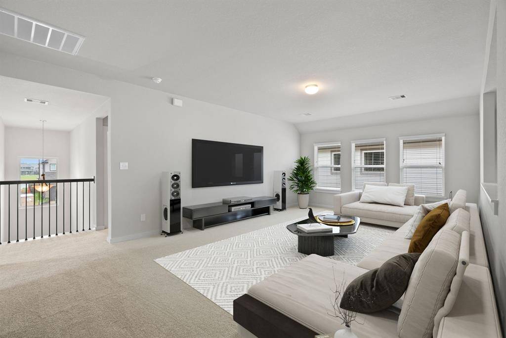 Ascend upstairs to openness: The modern and dark rail stains, coupled with sleek metal balusters, infuse this area  with a spacious and contemporary ambiance. Let it serve as an additional living area or game room, possibilities are endless.