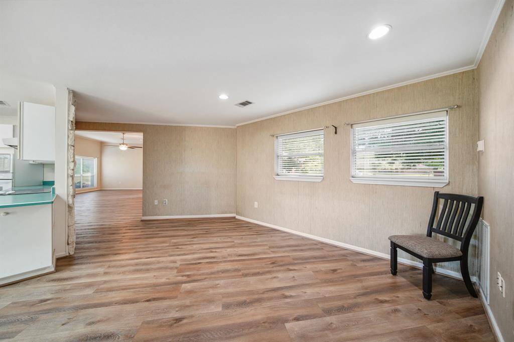 Open flex space off kitchen showing the large opening into the Family soace