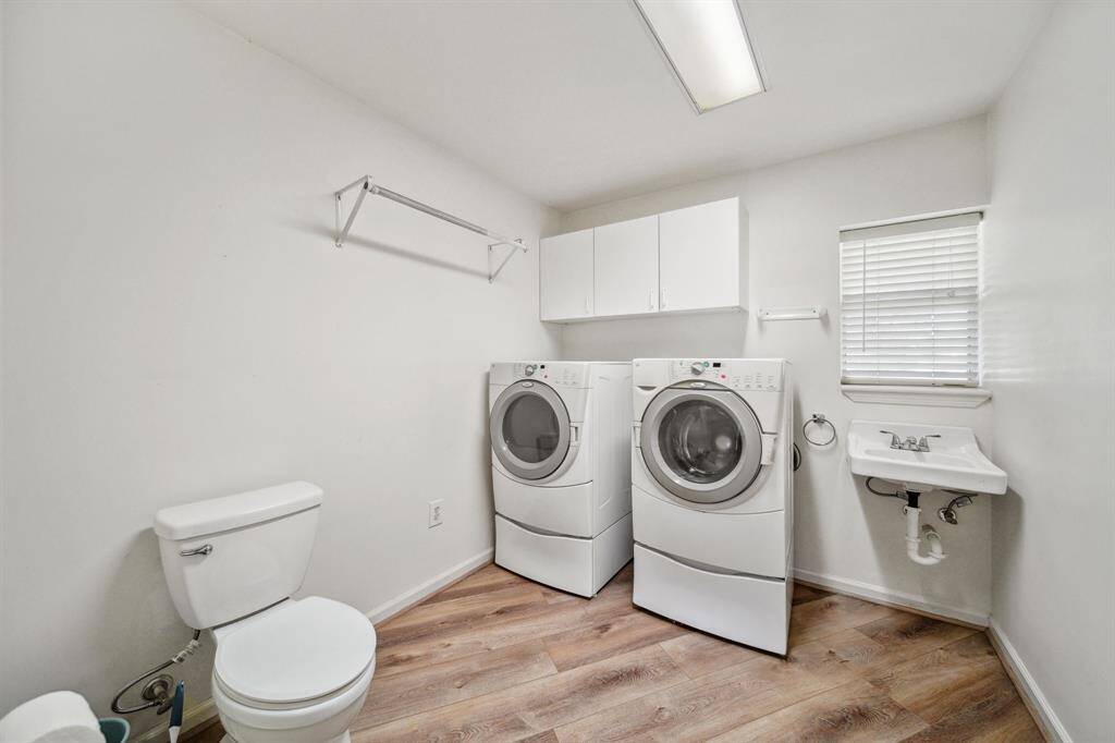 Laundry room just off the kitchen with sink.  There is room to enclose the toilet for privacy if desired