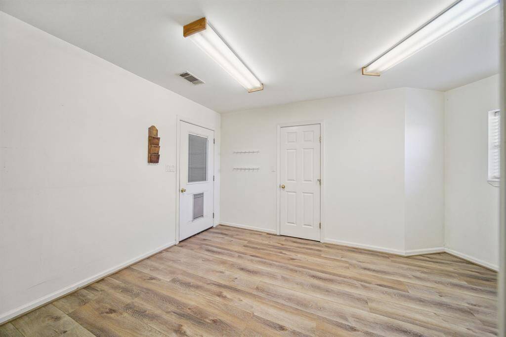 Another flex space/Office privacy door leading into 3 car garage access.  Other door is a very large closet with electricity panel, extra panel for a future generator, and shelving