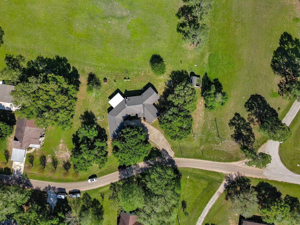 Drone view of home showing mature trees