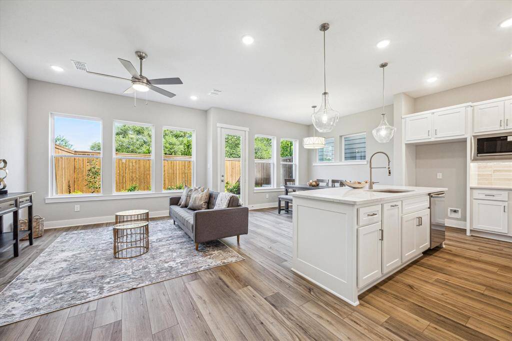 Views of the open living space and private backyard