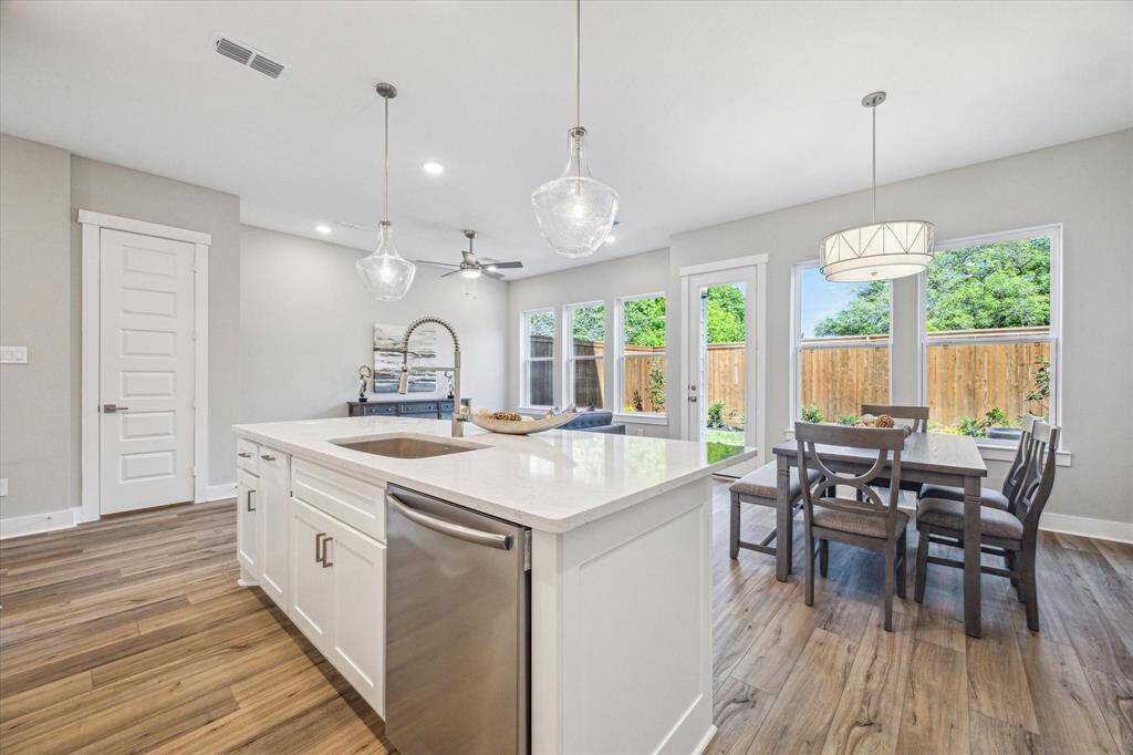 Abundant natural light throughout this open living space. A closet with shelving is conveniently located for additional pantry or storage space. The half bathroom is also discreetly tucked away.
