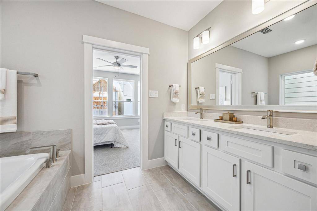 Double sinks and vanity storage with extra counterspace. Upgraded Moen plumbing hardware includes a lifetime warranty
