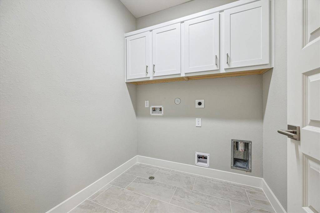 The utility room located on the second floor also includes upgraded upper cabinets