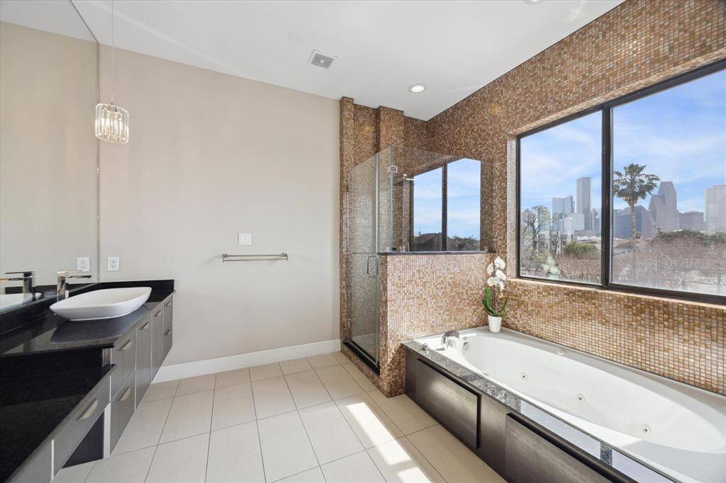 Enjoy the views while soaking in the tub or showering!  Large windows flood the room with natural light.