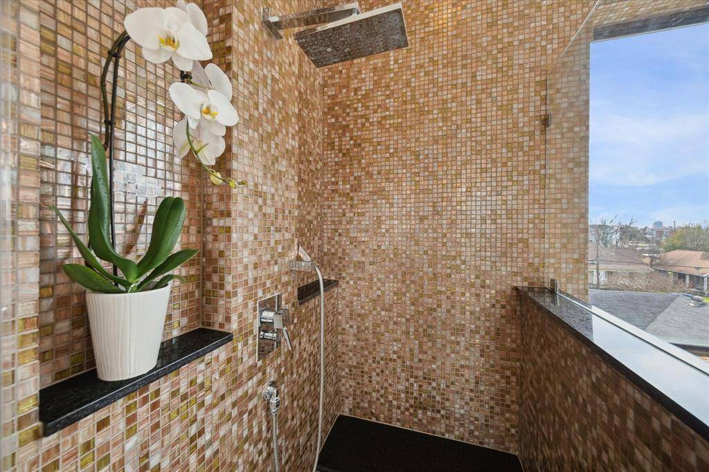 Large shower with custom mosaic tile work.