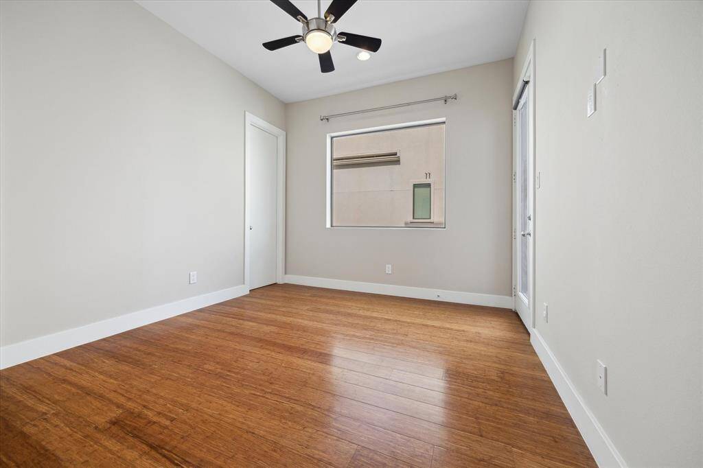 Secondary bedroom with beautiful wood floors, high ceiling, private balcony, and en-suite bathroom.