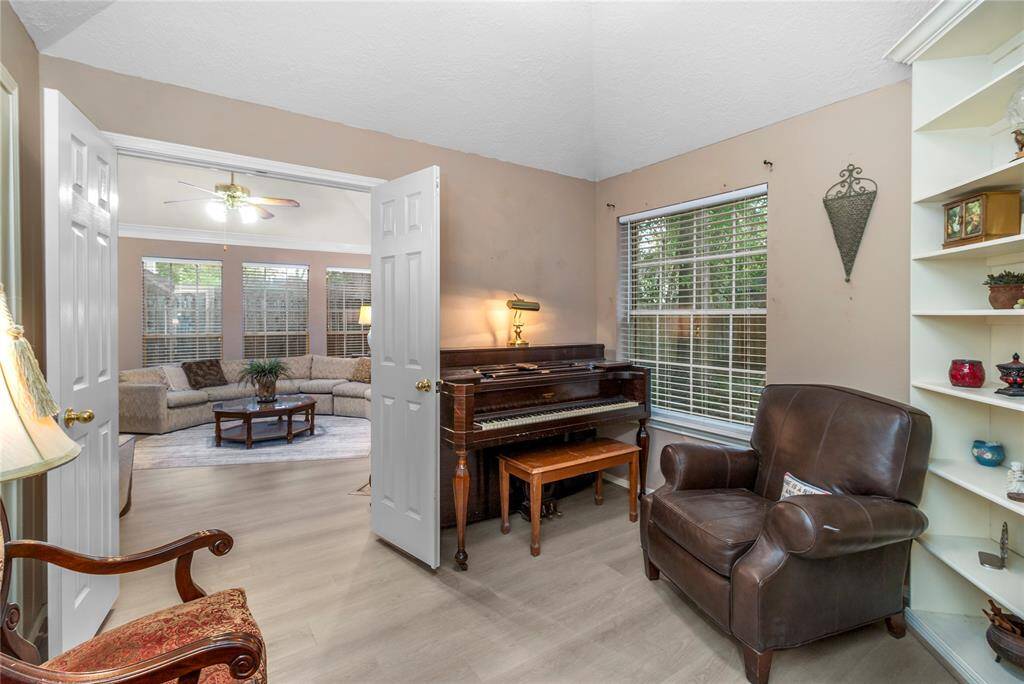 The home features a library with a piano. You'll love this cozy space.