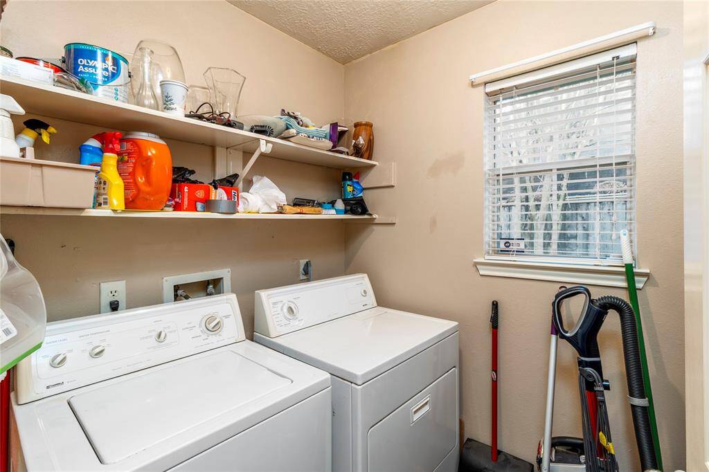 The utility room, featuring a washer and dryer, is just before the garage access.