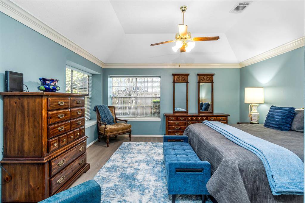 The beautiful, large primary bedroom features ample windows to let in the light1