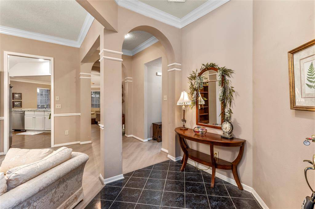 This home features numerous architectural touches included rounded entryways. This is the foyer opening to the rest of the home.