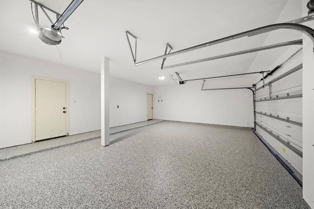 Oversized 3 car garage will fit all your cars and more! New epoxy flooring!