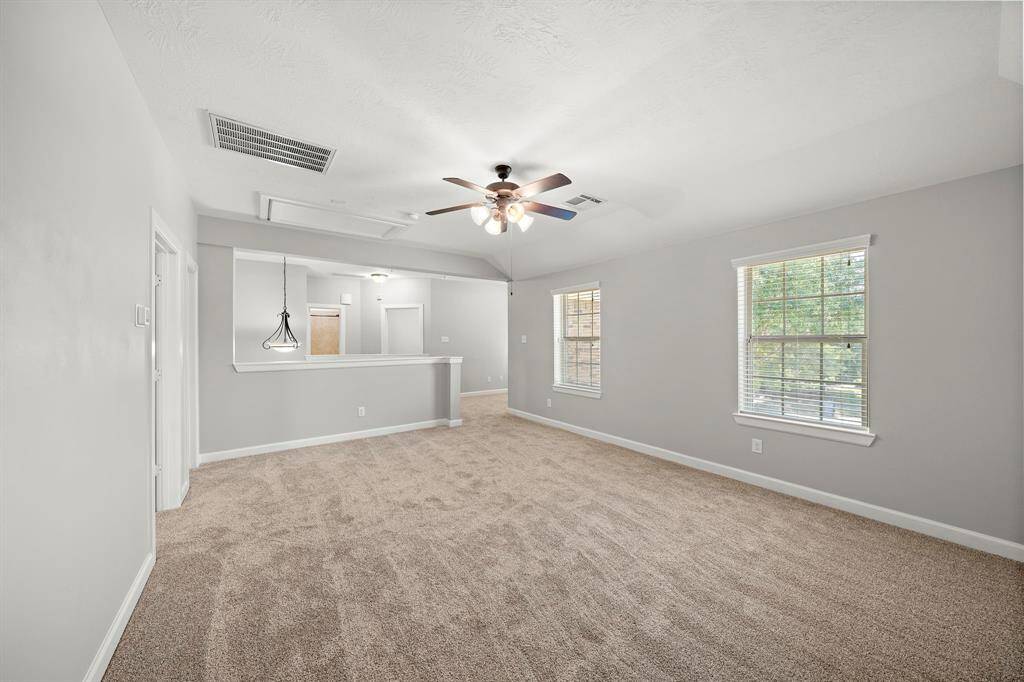 Large gameroom off of stairway landing features new carpet and natural light.