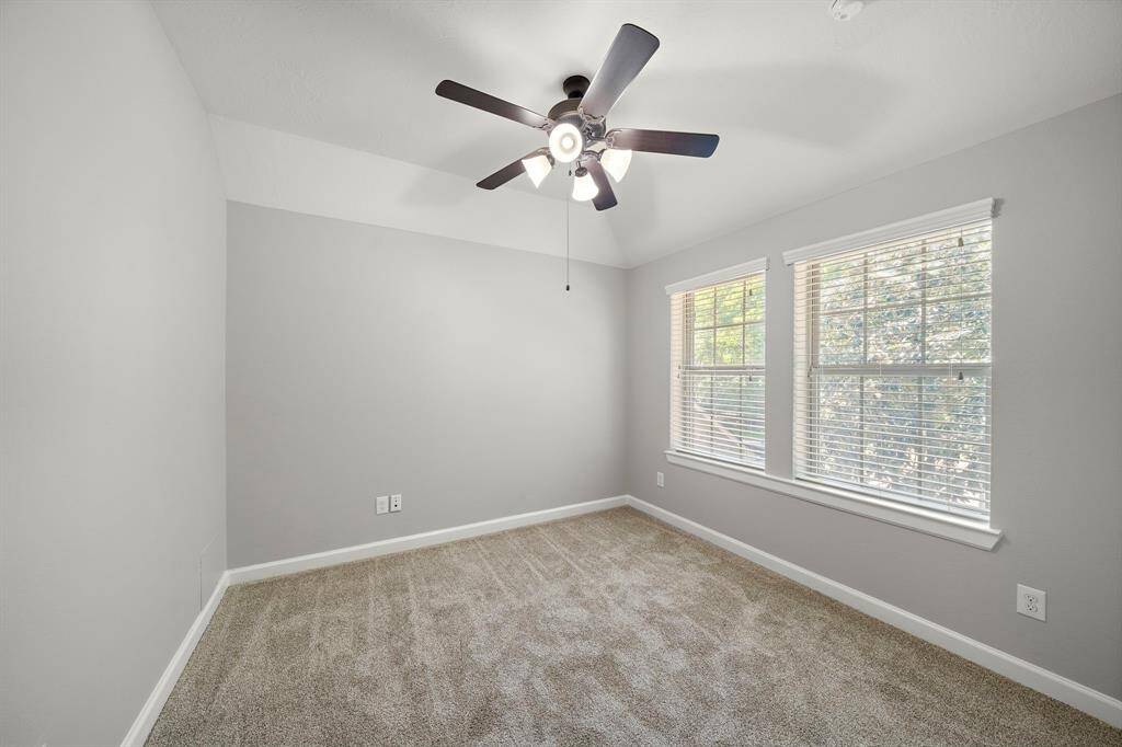 2nd Upstairs bedroom featuring new carpet and large windows.