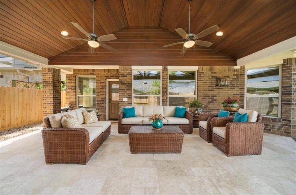 Large covered patio with travertine tile! Virtually staged.
