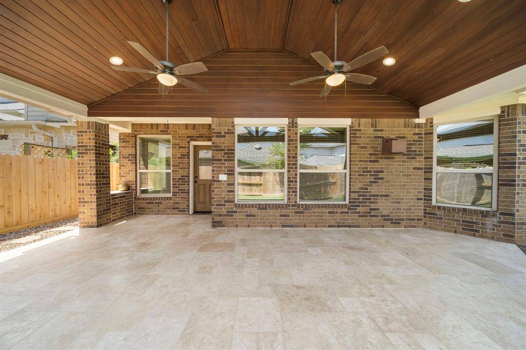 Large covered patio with travertine tile!