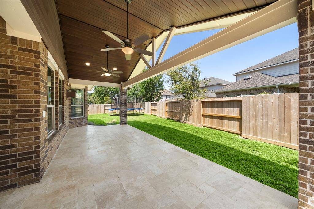 Large covered patio with travertine floors! New fence 2024