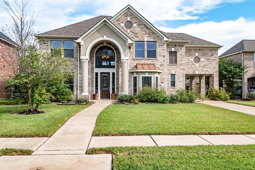 Discover elegance in this exquisite two-story residence nestled within a secure gated community.