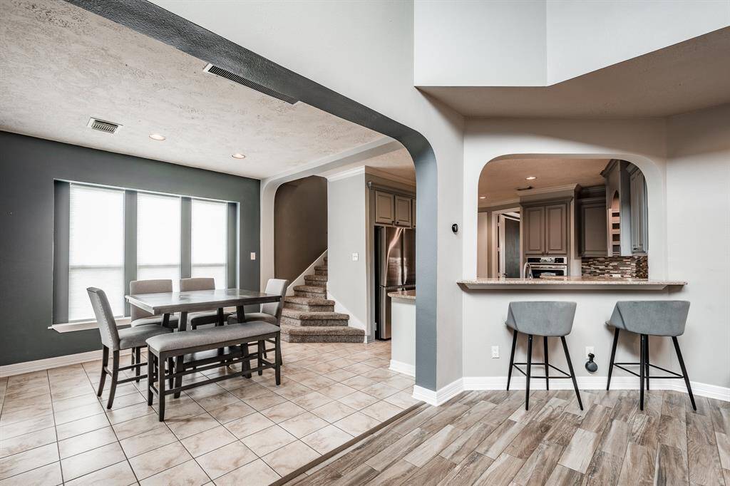 Seamlessly flowing from the inviting living room, this home features a sunlit breakfast area that transitions effortlessly into a modern kitchen, perfect for casual dining and entertaining.