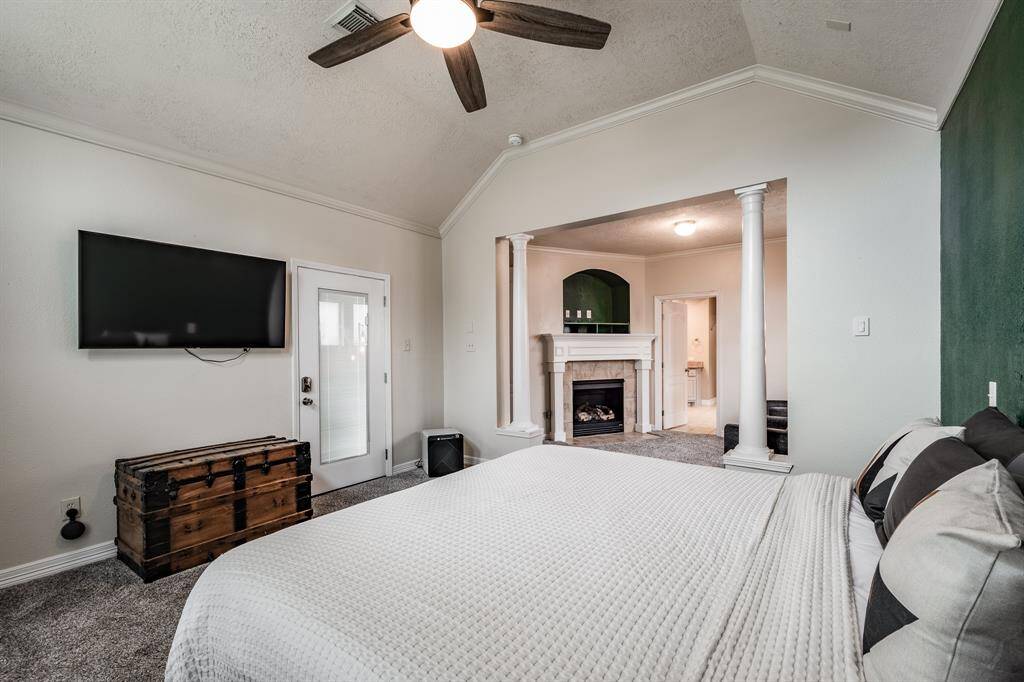 Experience serene luxury in the spacious primary bedroom, complete with a cozy sitting area by the fireplace, direct access to a private covered patio, and a spa-like en suite.