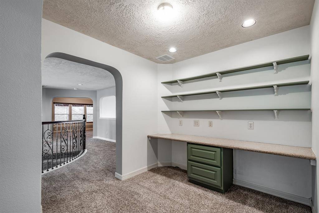 Upstairs features an elegant built-in desk with ample shelving—perfect for a home office, study nook, or crafting.