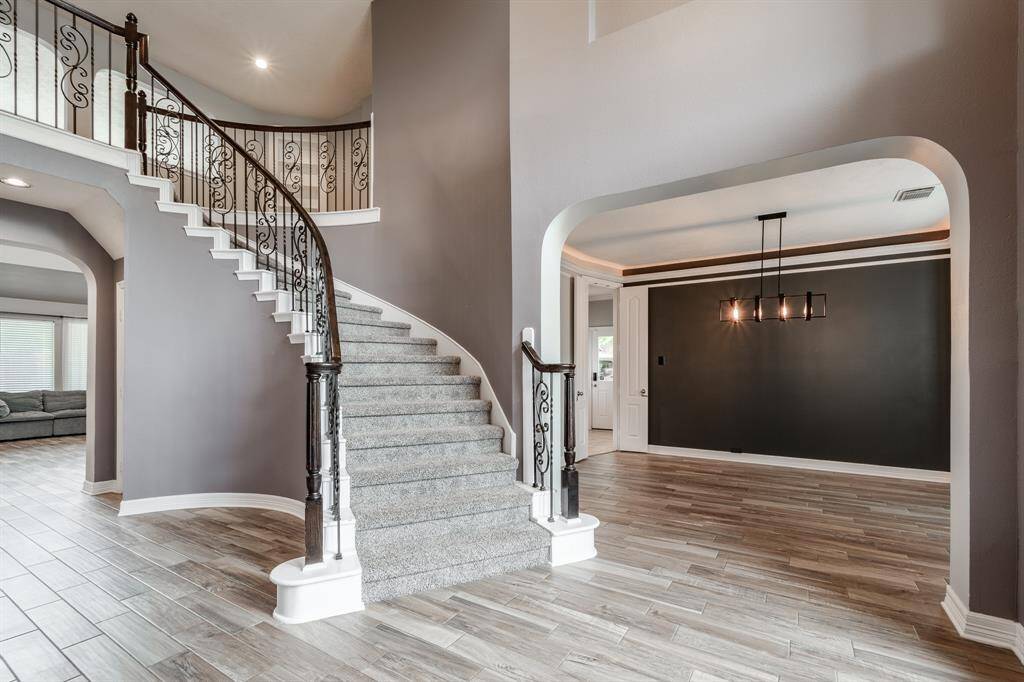 Welcome to a grand entrance with an elegant staircase, creating a captivating first impression.