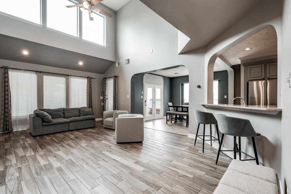 Step into the spacious living room with soaring ceilings & a cozy fireplace in the living room.