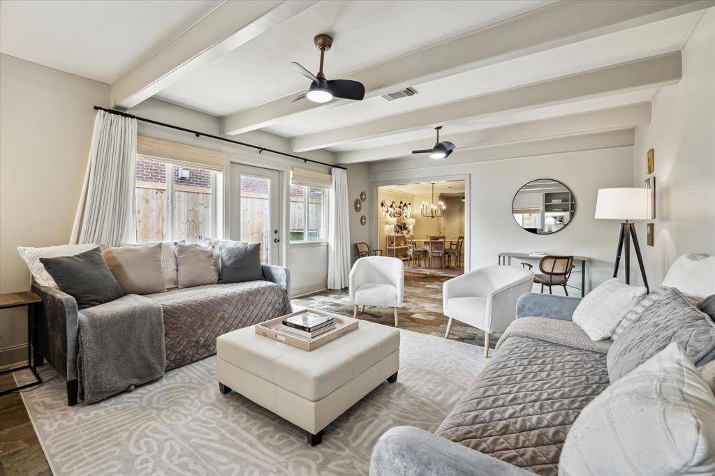 Exposed beams lend a touch of rustic elegance while creating an airy, inviting ambiance perfect for families of every size