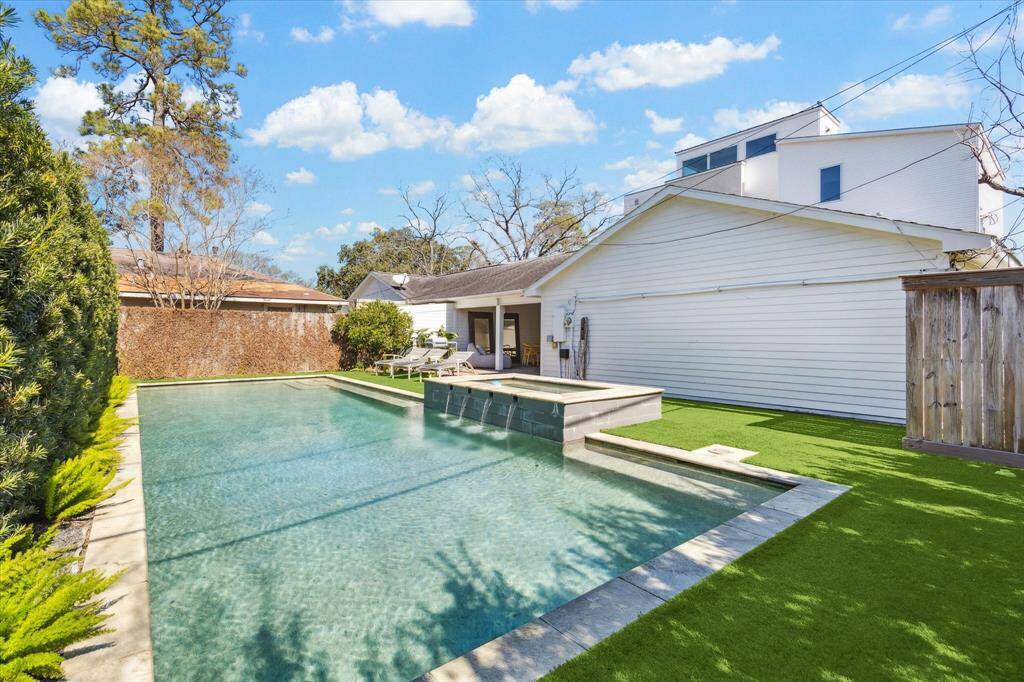 The serene pool retreat situated beyond the fencing, offering a private oasis for relaxation and leisure.