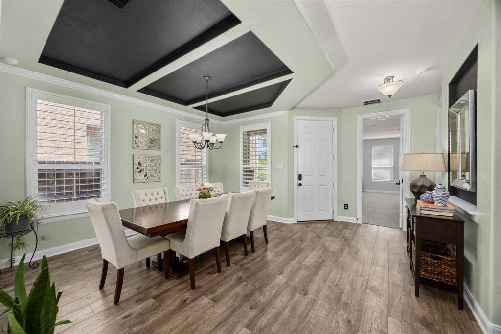 The formal Dining Room welcomes you as you enter the home. It features beautifully designed ceilings that gracefully draw the eye in, setting the perfect ambiance for gatherings.