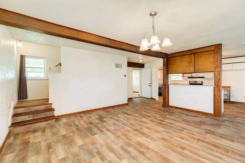 Dining Area is approximately 18' x 15'6". Buyer to verify all room measurements. The door to the left of the Kitchen goes to the 1st Floor Bedroom that is Virtually Staged as a Home Office in our photos.