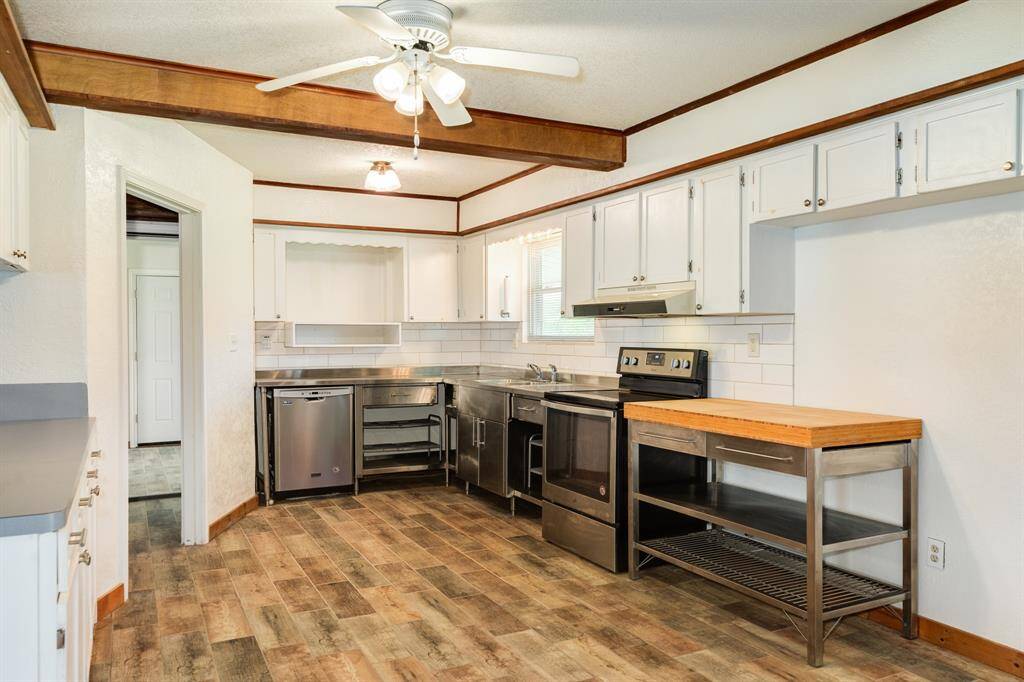 Another view of the Kitchen. These wood-look tile floors make clean-up a breeze.
