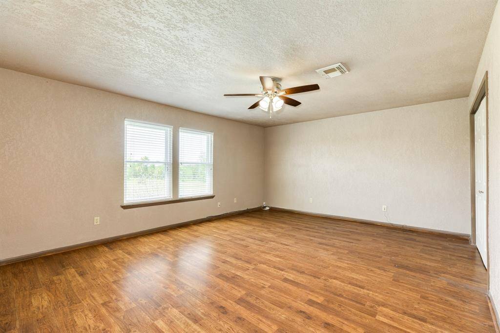 Current View of Primary Bedroom. There is a nice sized closet to the right of this photo. Also, there is an enormous walk-in closet in the bathroom upstairs which is approximately 11'5" x 6'4". Buyer to verify room measurements.