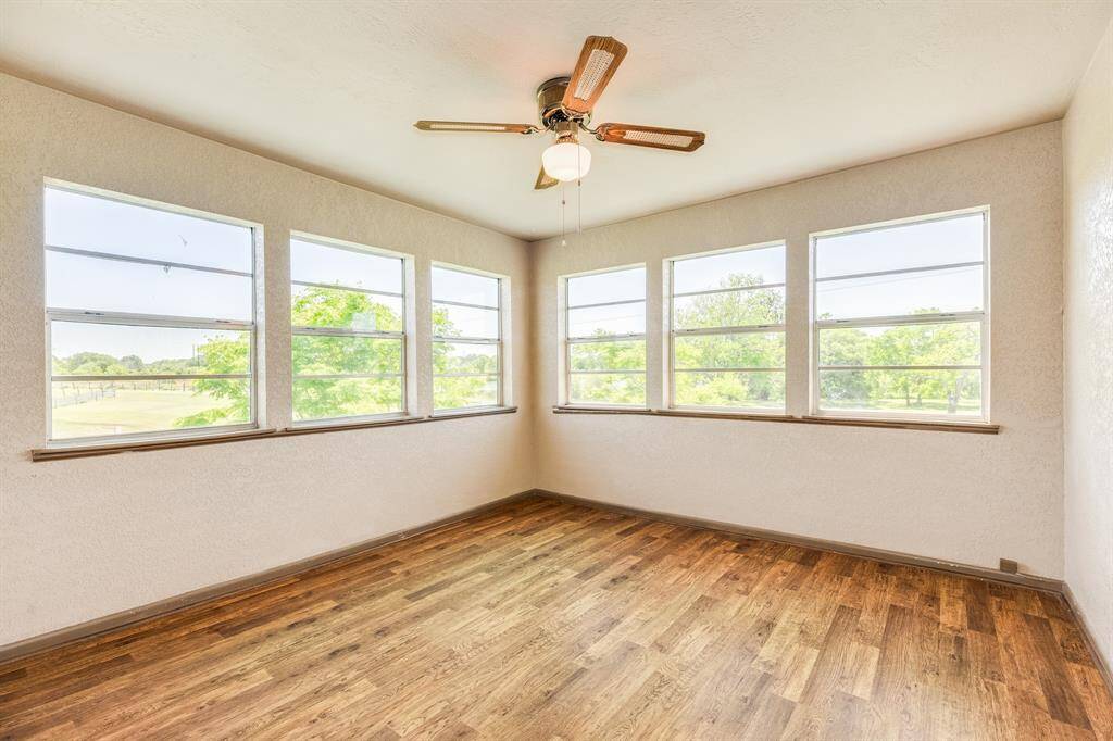 Sunroom Adjacent to Primary Bedroom. There is no closet, but there is a door to the bathroom & to the Primary Bedroom. This flex room could be a 2nd Living Area, a Sewing/Craft Room, or a Home Office & is a great place to watch Fireworks on July 4th!. It's approximately 12'2" x 11'8". Buyer to verify all room measurements.
