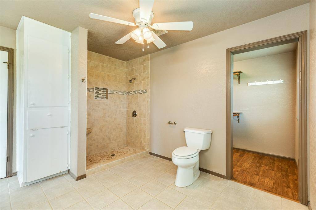 The door to the right of the photo is the entrance to the massive walk-in closet. Bathroom is approximately 11'7" x 11'2". Buyer to verify all room measurements.