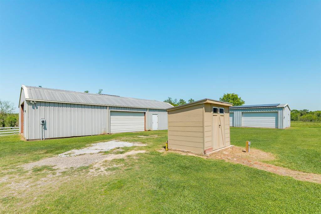 This photo shows the recent Well House and the Two 1,800 square foot Barns/Workshops on the property.
