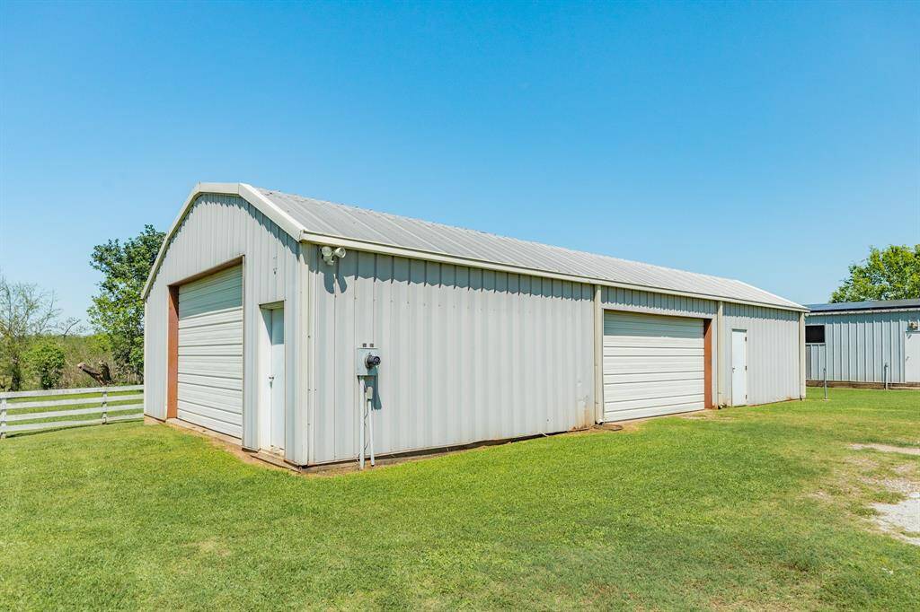 The walk-in door to the right of this building goes into a large unfinished storage room.