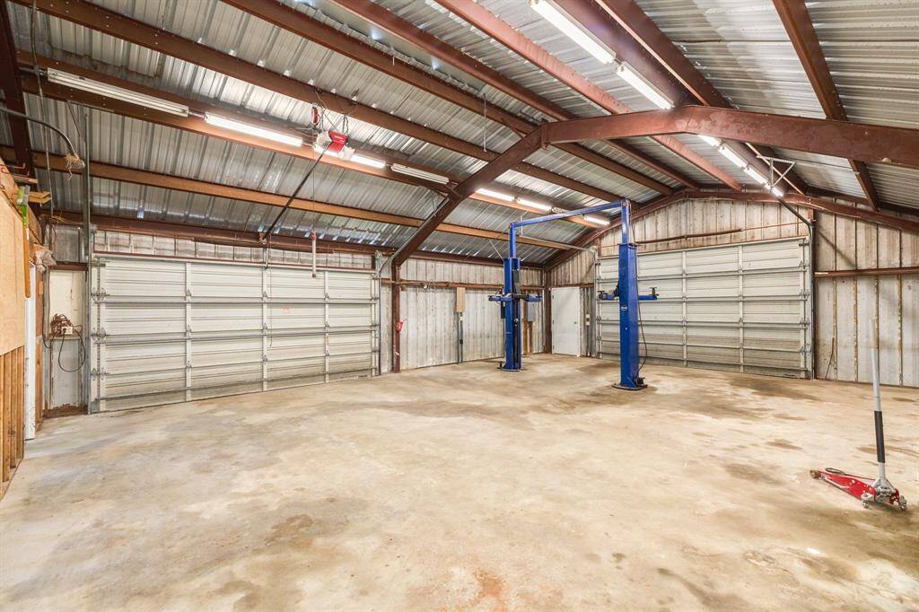 2 Double Garage Doors in this building. There may be parking available for 4 vehicles if you can get around the Lift. Vehicle Lift has not been used by current Owner, but it may be just the thing you need. Lift requires servicing.