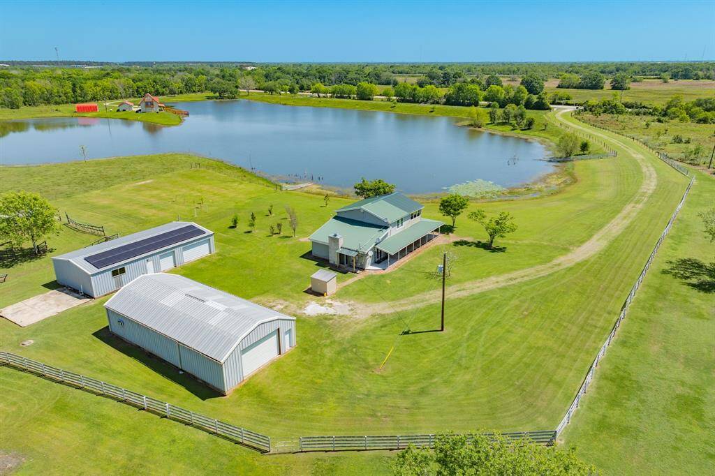 This Gorgeous Homesite has Two 1,800 square foot Barns/Shops that are really incredible - and a sparkling Lake/Pond that seems to wash your cares away.