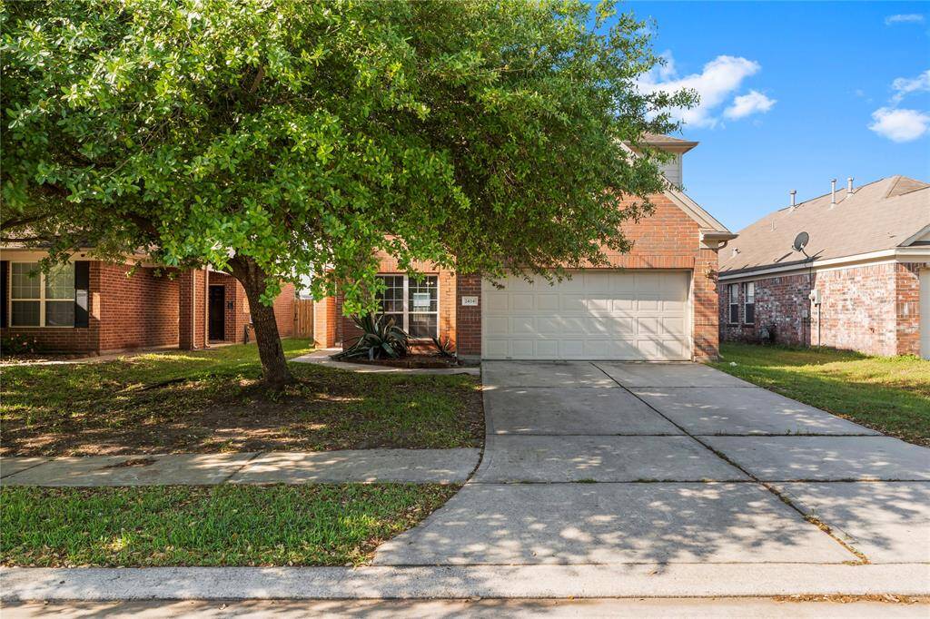 Charming brick home with a spacious driveway and attached two-car garage. The front yard features a mature tree providing shade and a welcoming ambiance. Perfect for families seeking a cozy neighborhood setting.