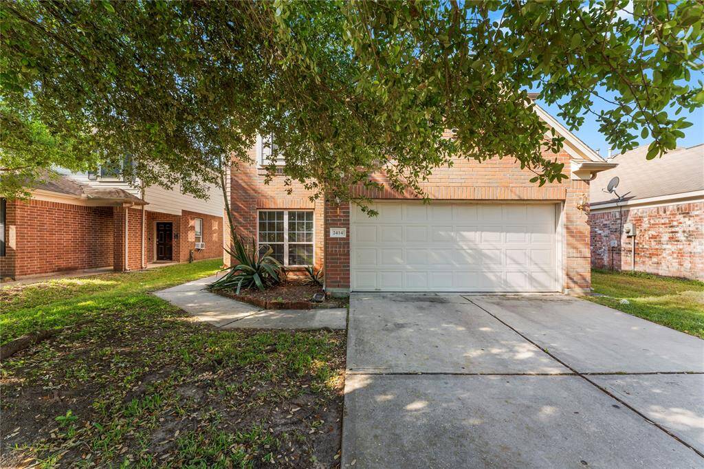 The exterior is a combination of brick and siding, giving it a classic suburban look.