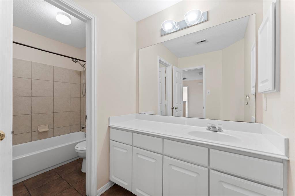 Secondary bath with oversized vanity and plenty of storage.