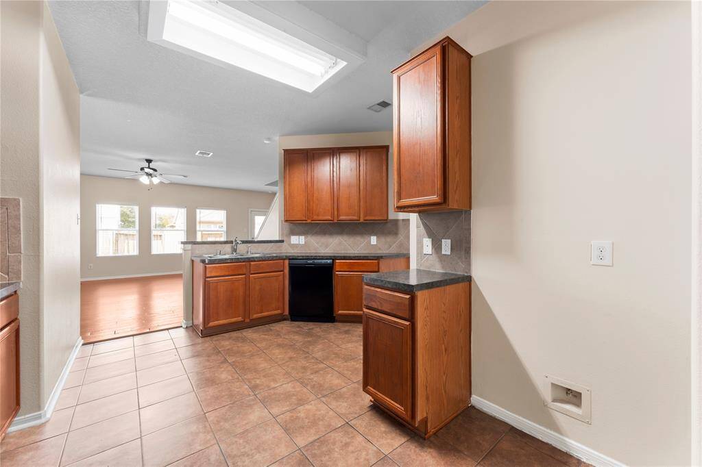 This kitchen offers an open view into the living area.