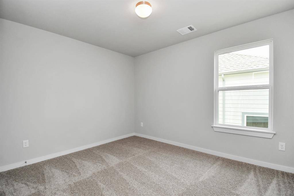 Generously sized secondary bedrooms, complete with spacious closets and soft, inviting carpeting. Sample photo, actual color and selections can vary.