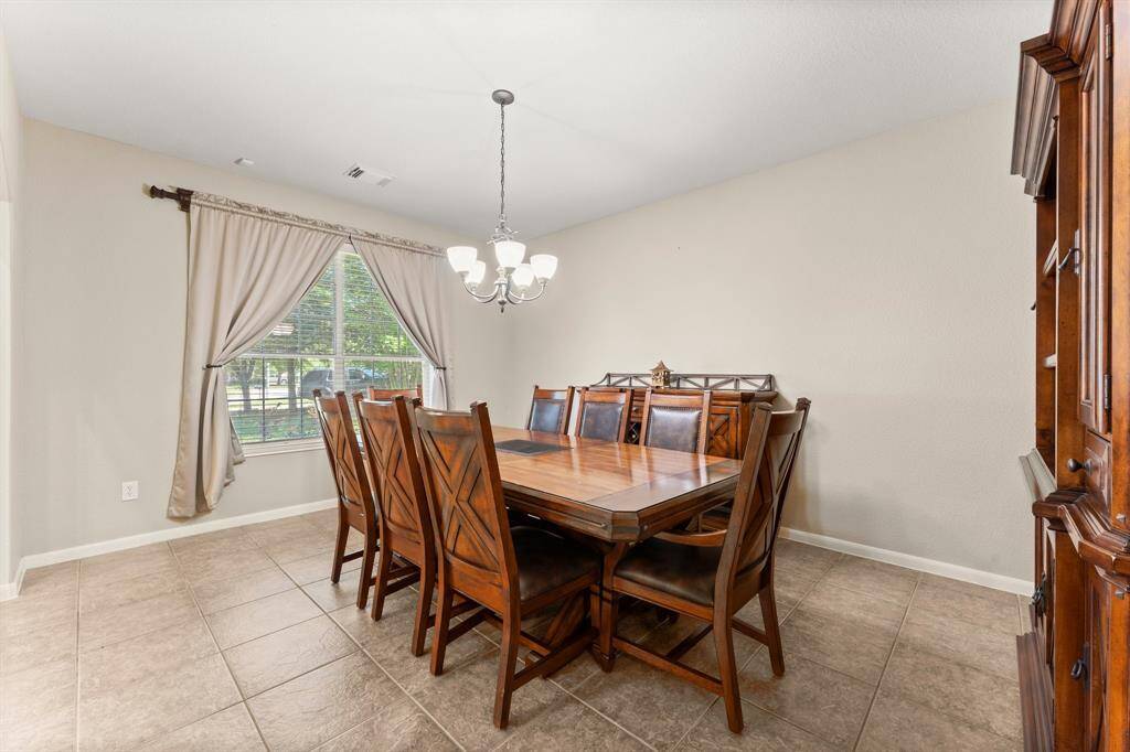 The formal dining room, located at the front of the home across from the office, provides an ideal space for hosting elegant dinners or enjoying meals with family and friends.