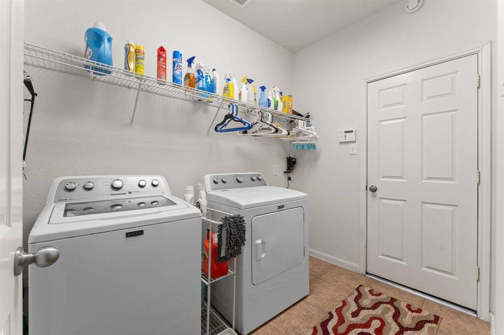 The oversized laundry room offers abundant storage and convenience, perfectly situated just off the 2-car oversized garage for easy everyday functionality.