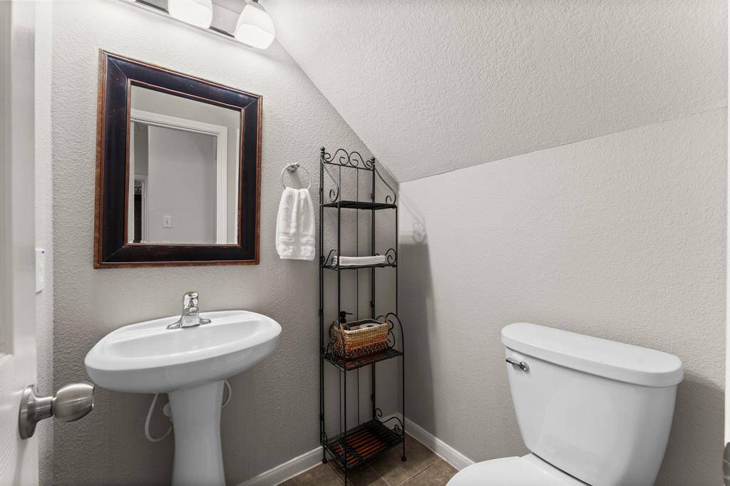 A convenient half bath on the first floor offers the perfect space for guests, combining function with thoughtful design.