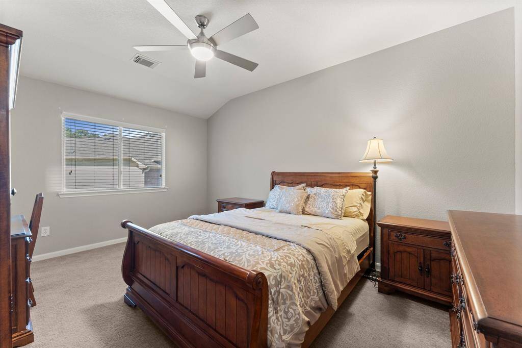 This spacious upstairs bedroom offers plenty of natural light, ample closet space, and a versatile layout, making it perfect for family, or guests.